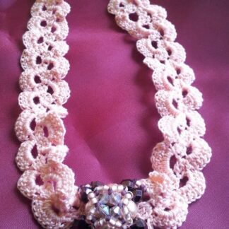 Crocheted pink chocker with beaded element